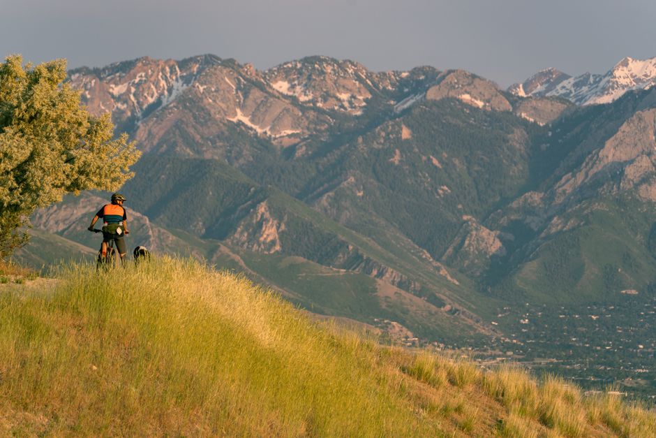 A man mountain biking along a trail in the scenic Wasatch Mountains near Salt Lake City, U