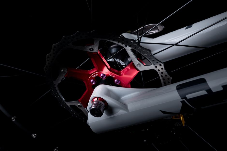Detailed view of a bicycle disc brake rotor and caliper assembly.