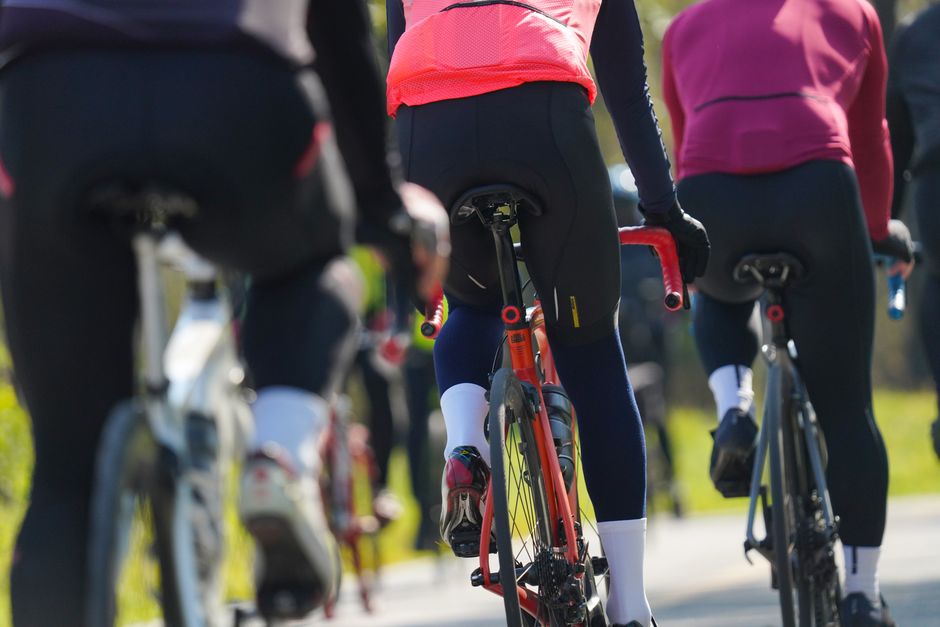 Group of cyclists riding on a sunny day, showcasing endurance and teamwork in outdoor spor