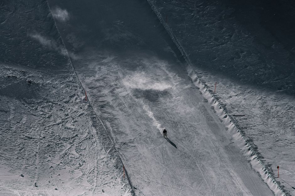 A skier descends a snowy slope in Serfaus, Tirol during winter.